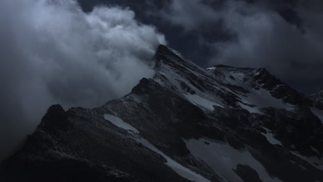 dark mountain peak under stormy clouds