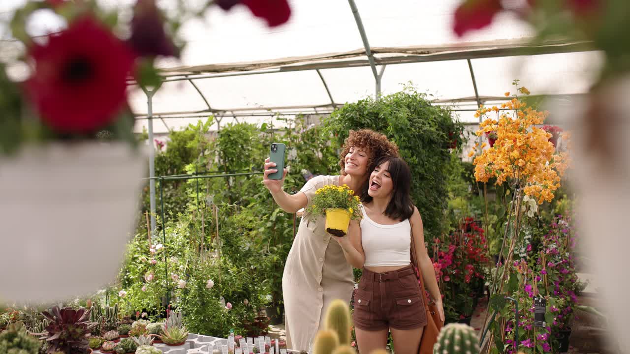 Customers taking selfies with flowers in garden center