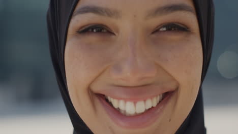 close up portrait mulsim woman smiling in city