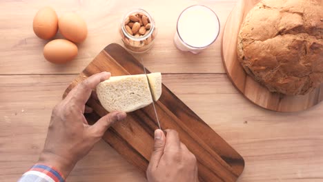 preparing a simple breakfast with cheese, bread, and eggs