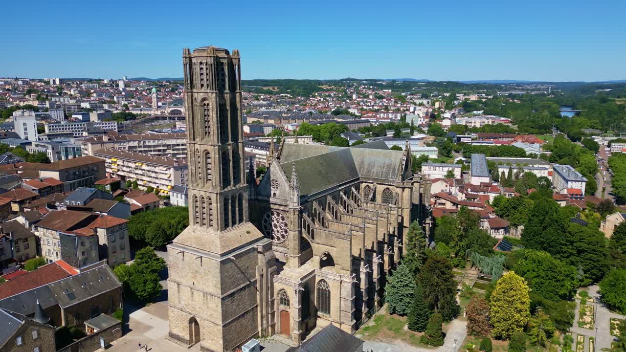 Aerial shot ascending with upward tilt, showing Saint-Etienne Cathedral in Limoges with surrounding houses and buildings - France