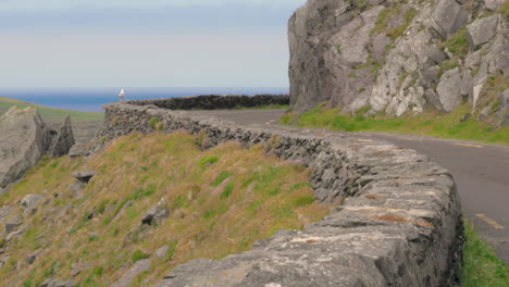 scenic route along road in dingle, ireland - slow zoom out