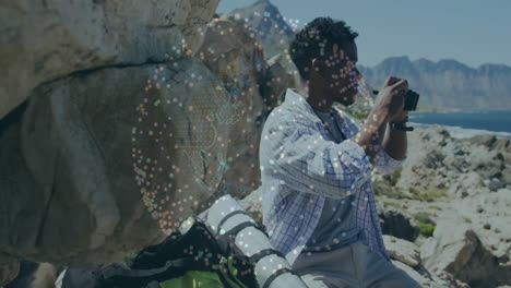 man adjusting camera settings on rocky shoreline, with dynamic animated photography histogram graph