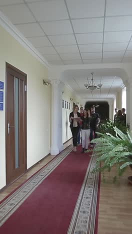 university or college students chatting in the hallway