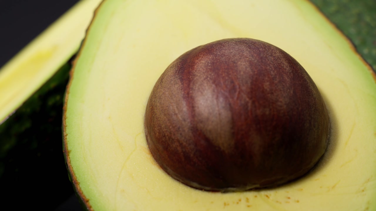 SLOW MOTION CLOSE UP SHOT OF A BEAUTIFUL AVOCADO SLICE FROM MEXICO