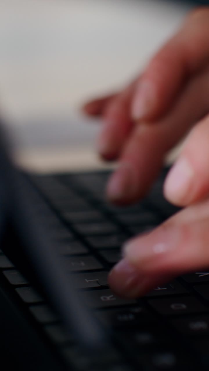 Person Typing on a Laptop Keyboard