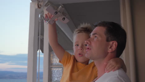 Father-and-child-playing-with-toy-plane