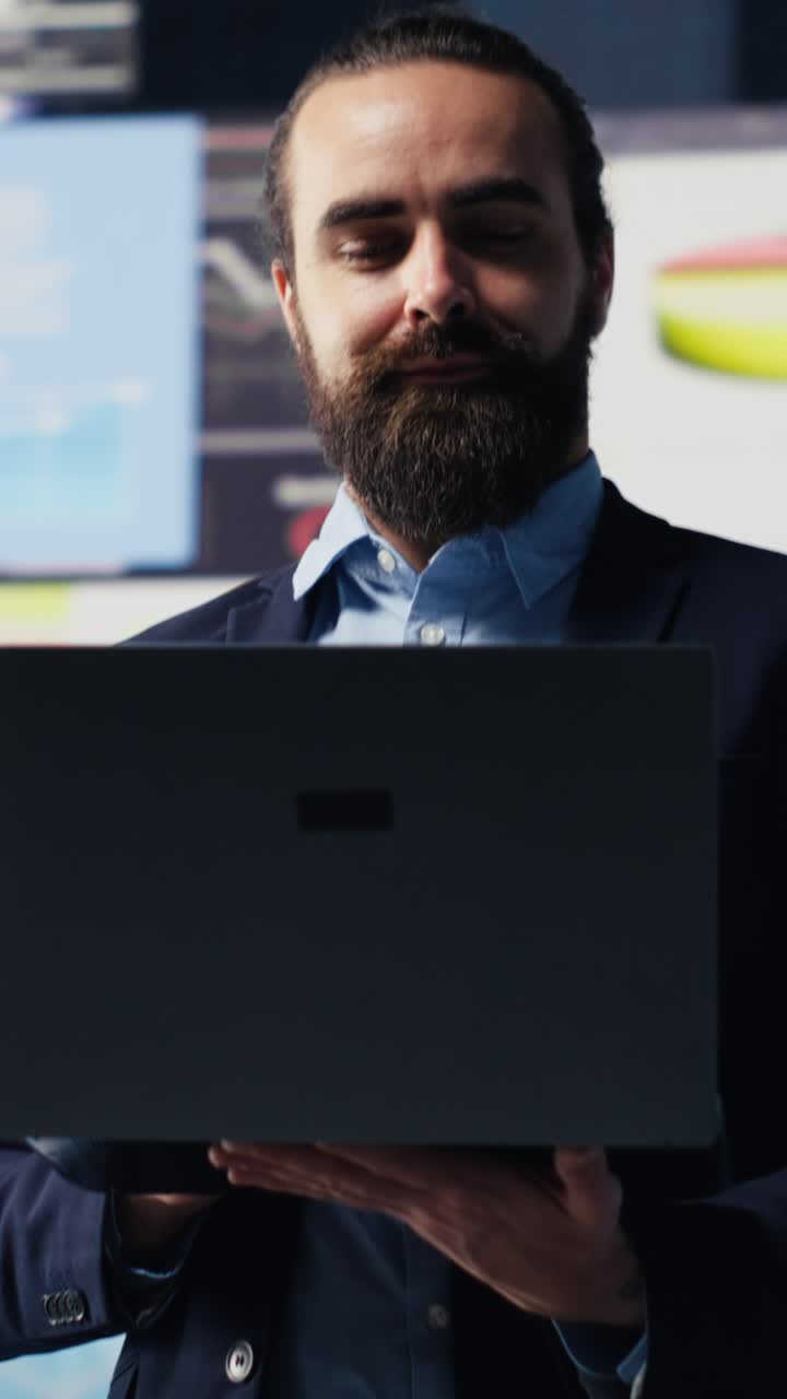 Vertical Video Young startup entrepreneur uses materials and analytics to improve development