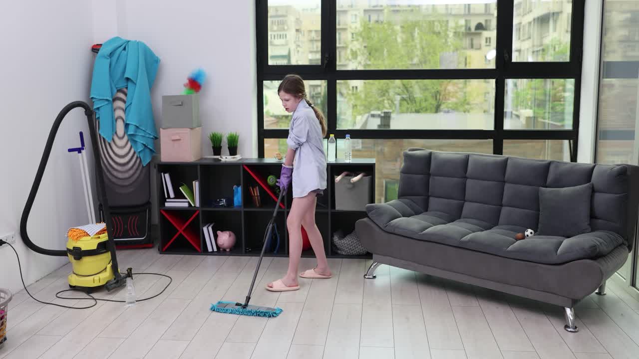 Girl mopping the floor at home