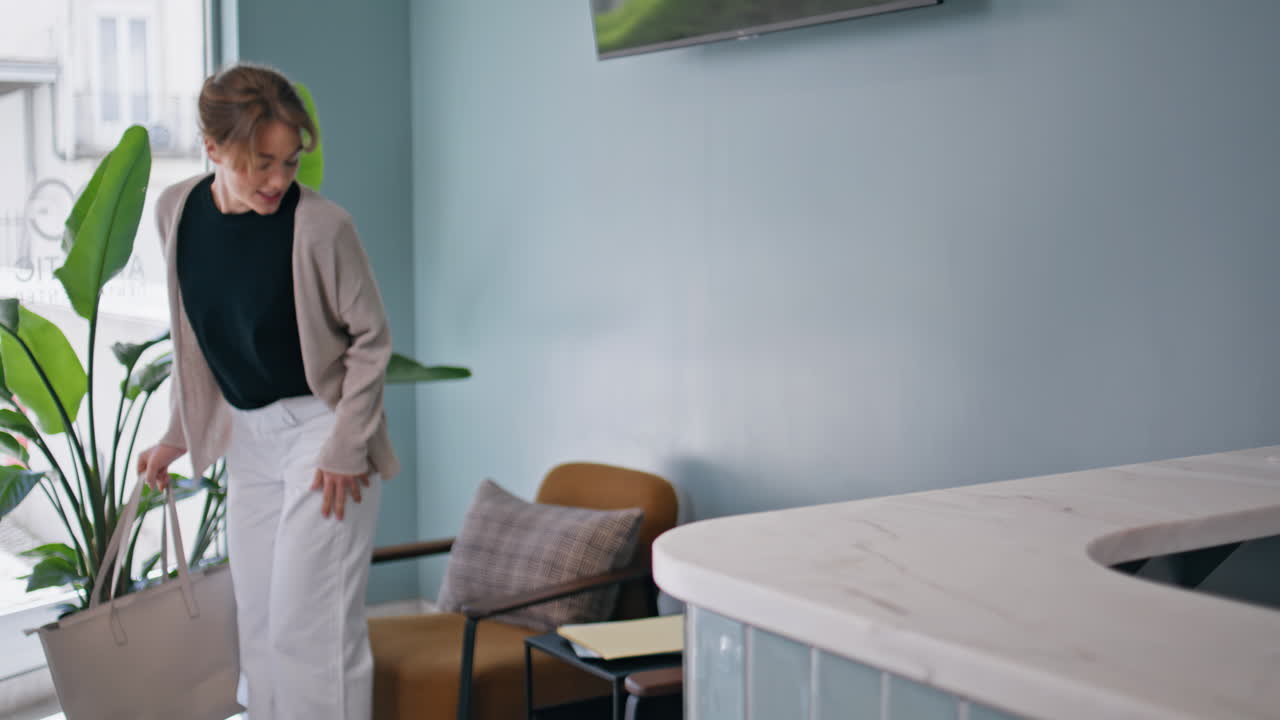 Woman patient talking receptionist at healthcare appointment. Smiling client