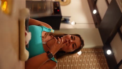 woman savoring a gourmet dish and trying not to smile when she is eating. vertical shot