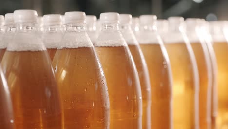 conveyor belt with bottles for juice or water at a modern beverage plant. modern production of sweet soda water