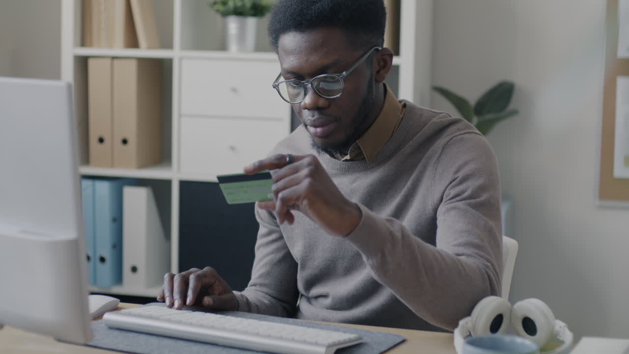 African American Man Paying Online with Credit Card
