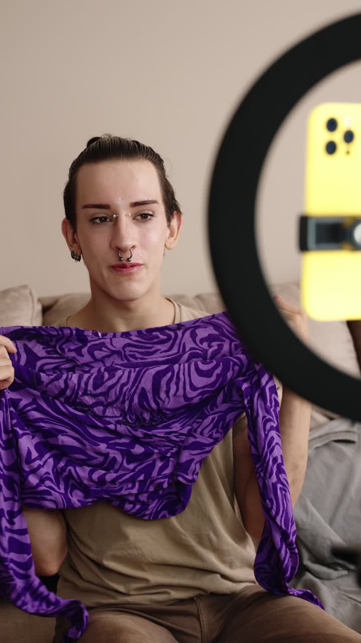 Person taking a selfie with ring light and showing a scarf