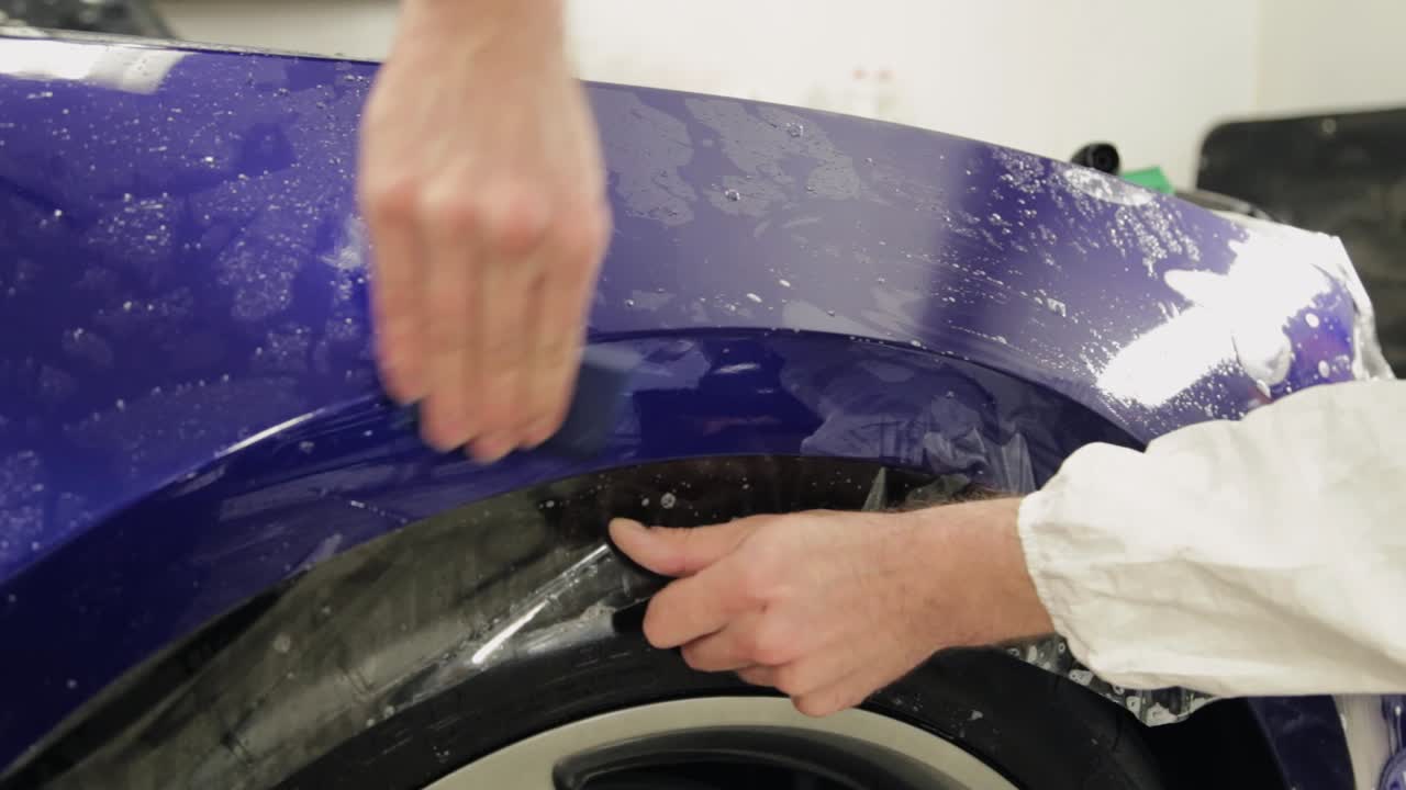 Applying protective film to a car's fender