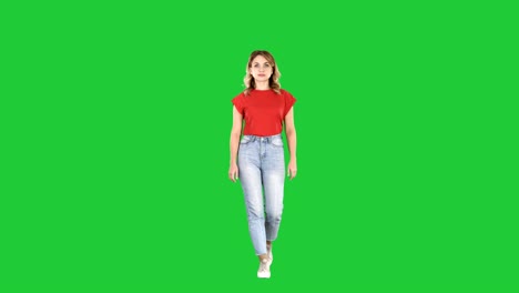 casual woman walking and smiling on a green screen, chroma key