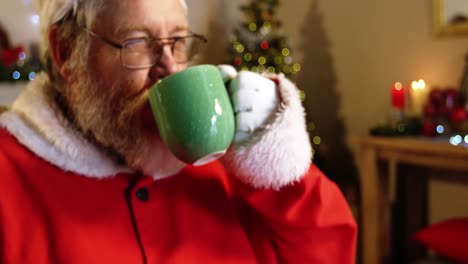 santa claus relaxing on chair and having coffee