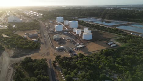 Aerial-approaching-shot-of-industrial-grain-factory-with-silo-storage