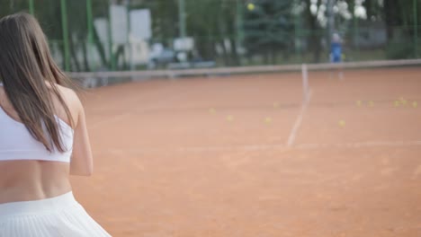 female tennis player practicing serve on outdoor court