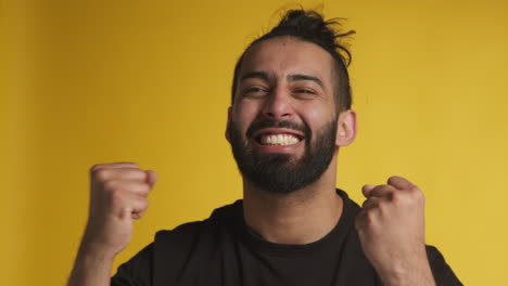 studio portrait of excited man celebrating good news winning money against black background 1