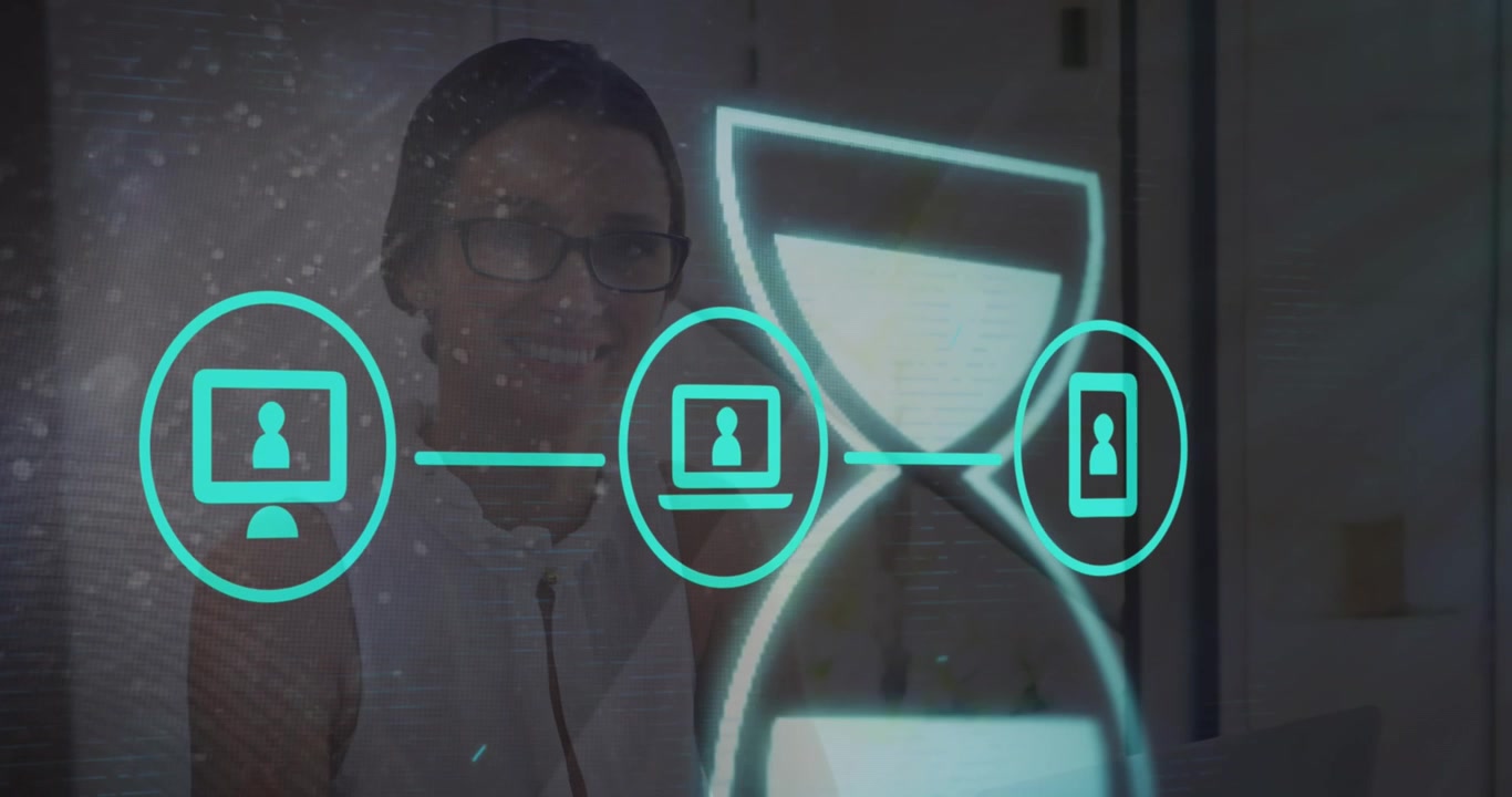 Animation of hourglass and tech icons over caucasian woman working on laptop