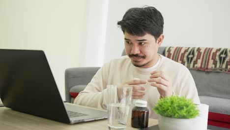 slow motion scene of middle east adult man  sneezing and use tissue paper swipe on face and drink water while working at home for coronavirus and quarantine time concept