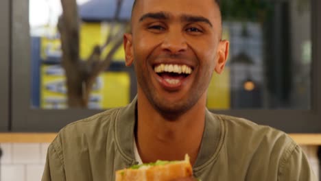 portrait of male executive having burger 4k