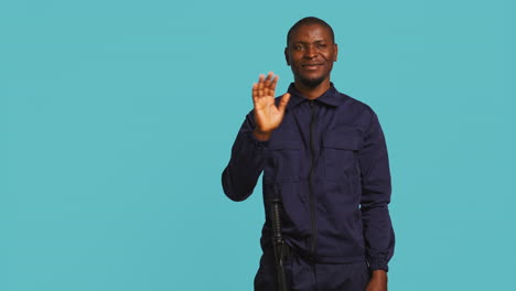 Portrait-of-jolly-bodyguard-waving-hand-towards-visitors