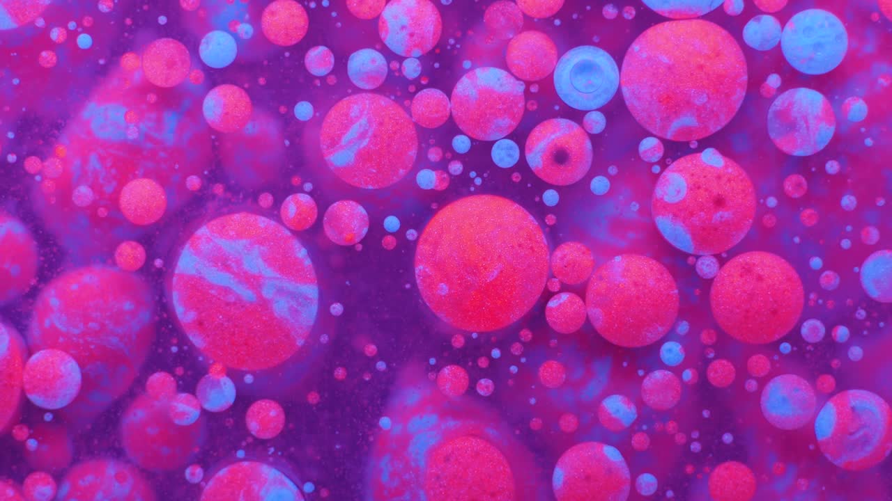 Slow Motion Bright Neon Color Bubbles Oil Beautiful Fluorescent Paint Sparkling Color Moving Multicolor Close up. Acrylic Neon Paint. Fantastic Surface. Abstract Colorful Transformation Gravitation.