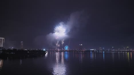 fireworks for lunar new year and tet holiday reflecting in the han river in danang, vietnam