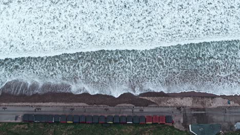 Saltburn-By-The-Sea,-Aerial-Footage,-DJI-Inspire-2-–-Clip-12,-Movement:-Straight-90-degree-overhead-shot-waves-and-beach-huts