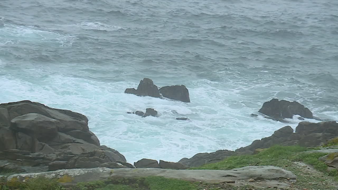 Ocean waves crashing against rocky coast