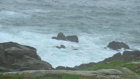 ocean waves crashing against rocky coast