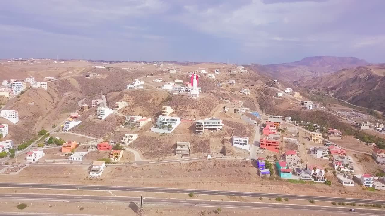 View from a drone flying over the Cristo del Sagrado Coraz&oacute;n which is located above the town of El Morro