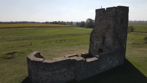 Close-aerial-parallax-around-ruins-of-truncated-tower-in-Soltszentimre,-Hungary