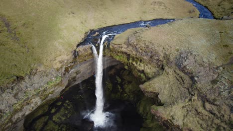 Dramatic-Iceland-volcanic-landscape-with-waterfall-in-autumn,-aerial-rising