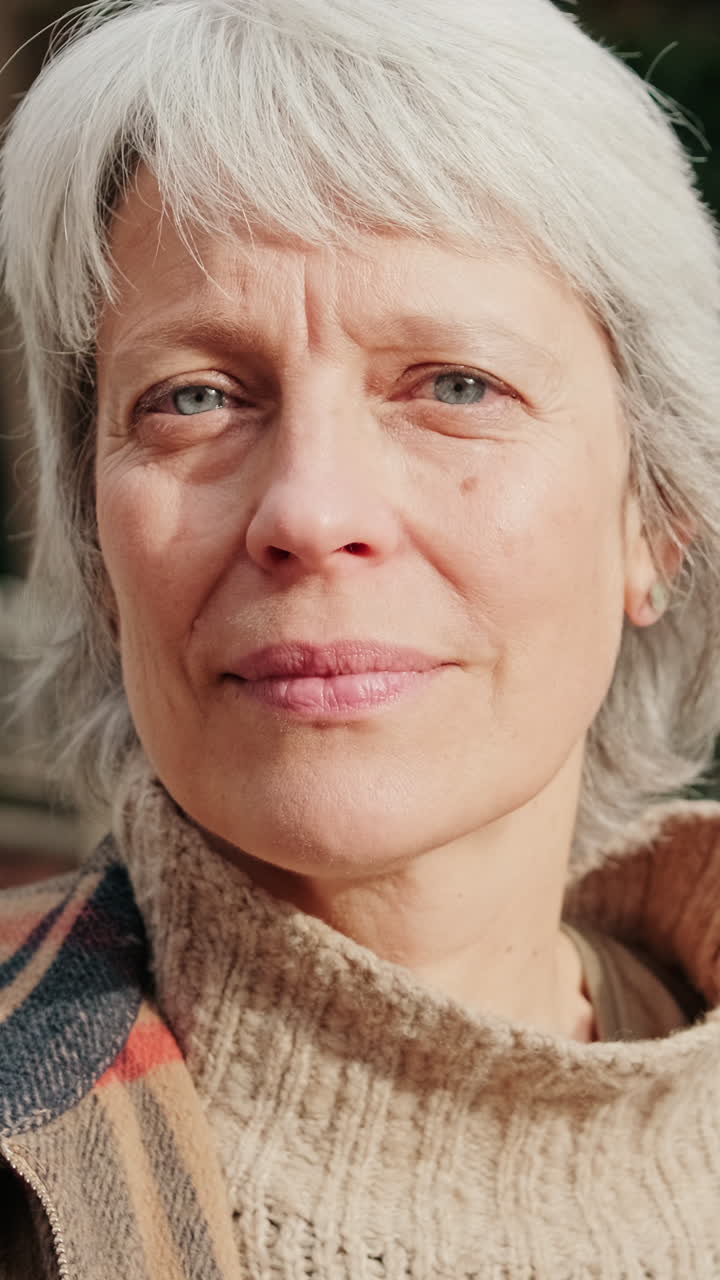 Close-up Portrait of a Senior Woman with Grey Hair Looking at Camera