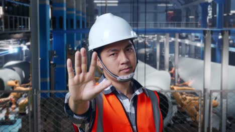 factory worker signaling stop