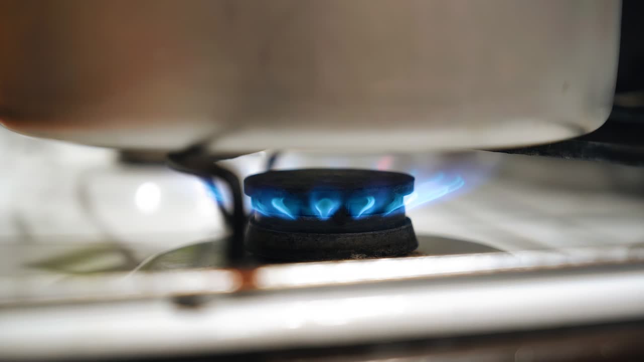 Close-up of burning gas on the gas stove in the kitchen. cooking food