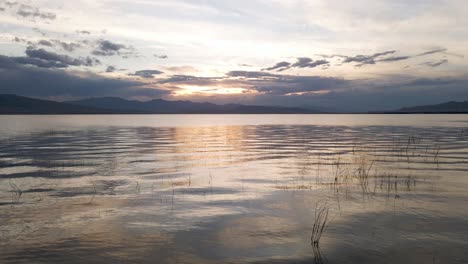 dramatic sunset over utah lake, low aerial 4k footage