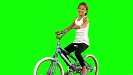 Little-girl-riding-bike-on-green-screen