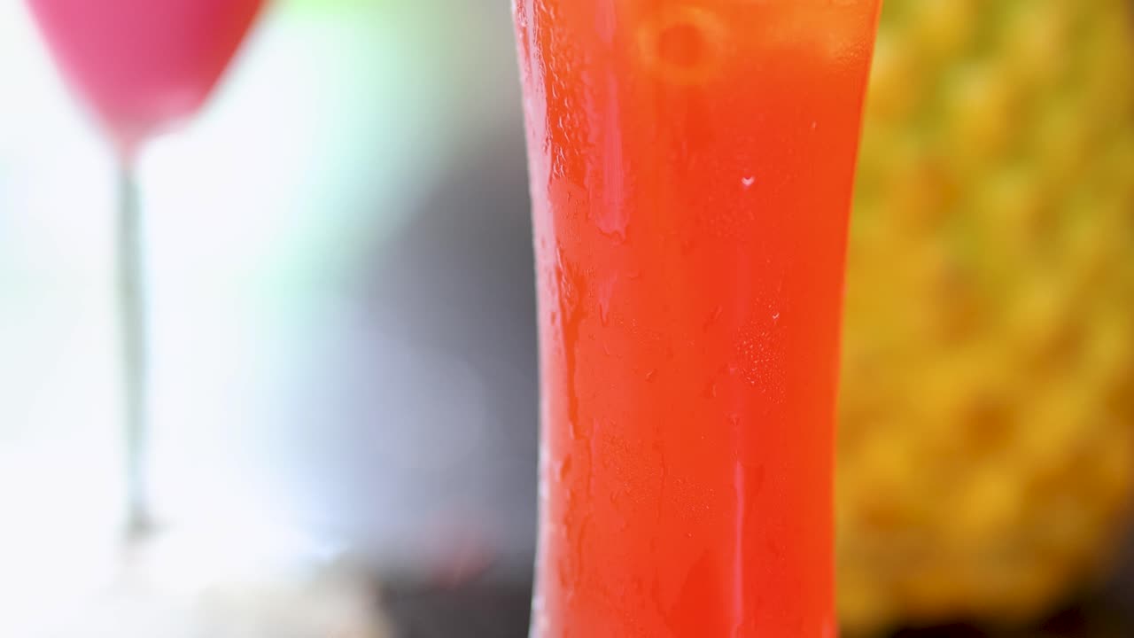 Refreshing cocktail with cherry and pineapple garnish