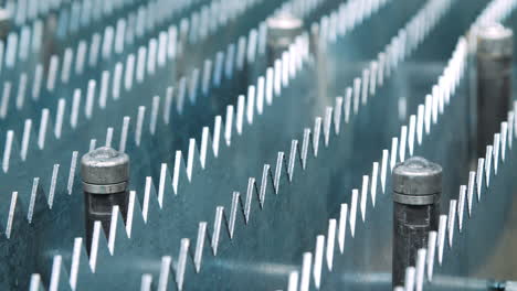Rows-of-metal-plates-with-sharp-edges-in-machine-tool.-Manufacturing-process