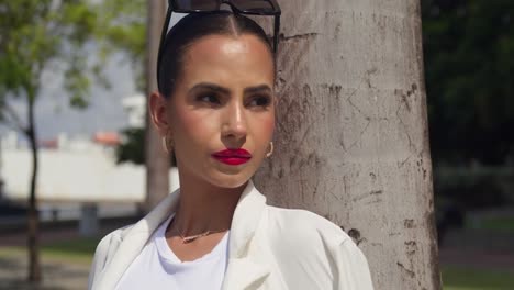 facial close up of a young pretty girl in the city wearing a white business suit