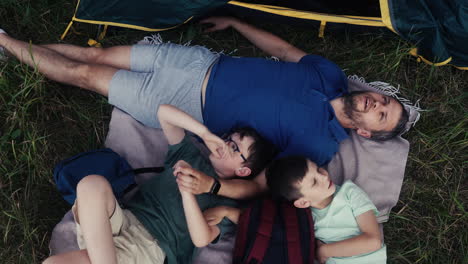 man and kid camping in the nature