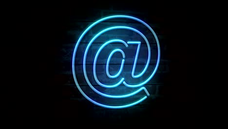 e-mail at neon symbol on brick wall