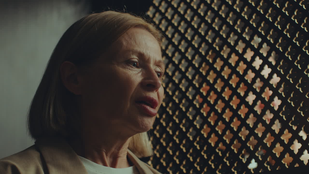 Mature Female Penitent Confessing to Priest in Church