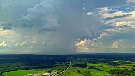 stormy cloudscape over green plain meadows in countryside town