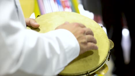 tambourine player at concert, flat plane, video, closeup