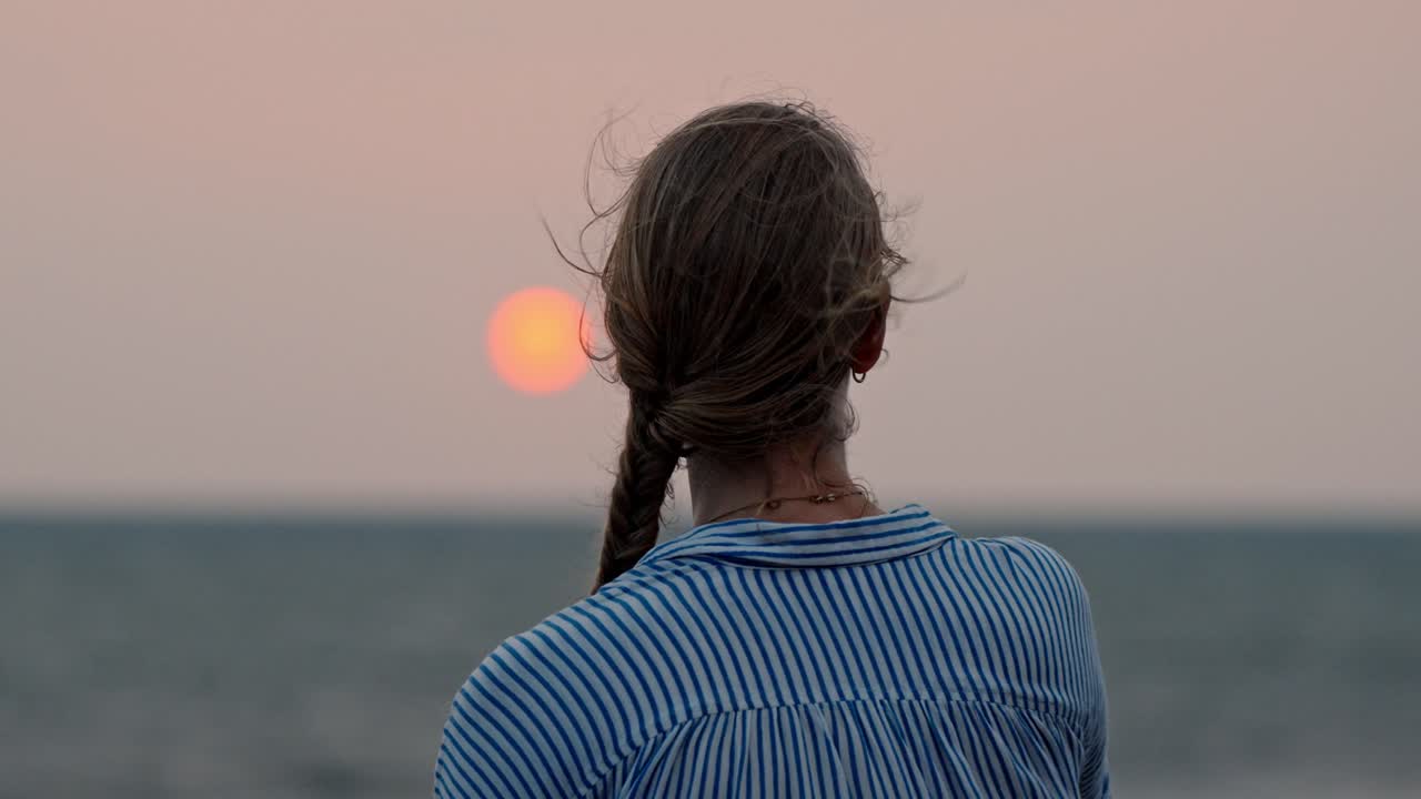 A serene moment in Galle, Sri Lanka, as a woman gazes at the vast ocean during a breathtaking sunset.